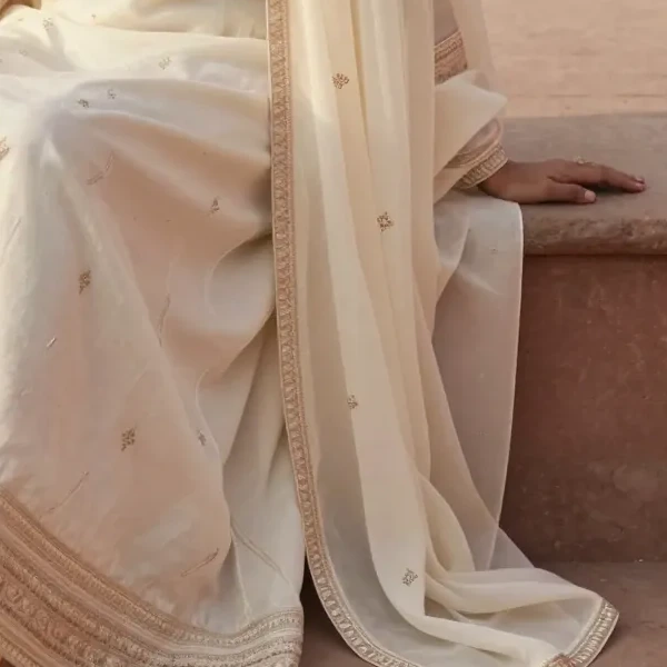 A sheer dupatta and fine gota border over ivory silk