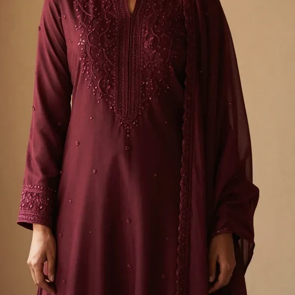A hand-embroidered yoke and sleeve border on oxblood silk
